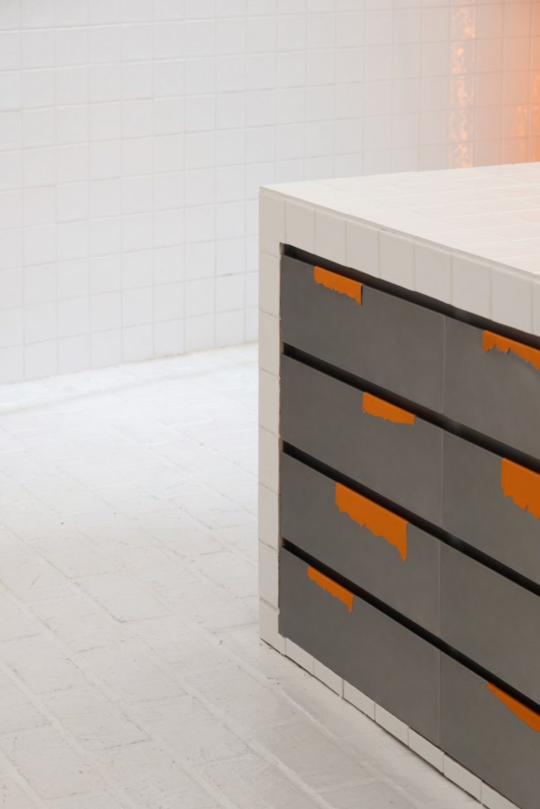 Деталь подиума с плиткой и оранжевыми акцентами PMW Next-Gen Street Culture Label Store