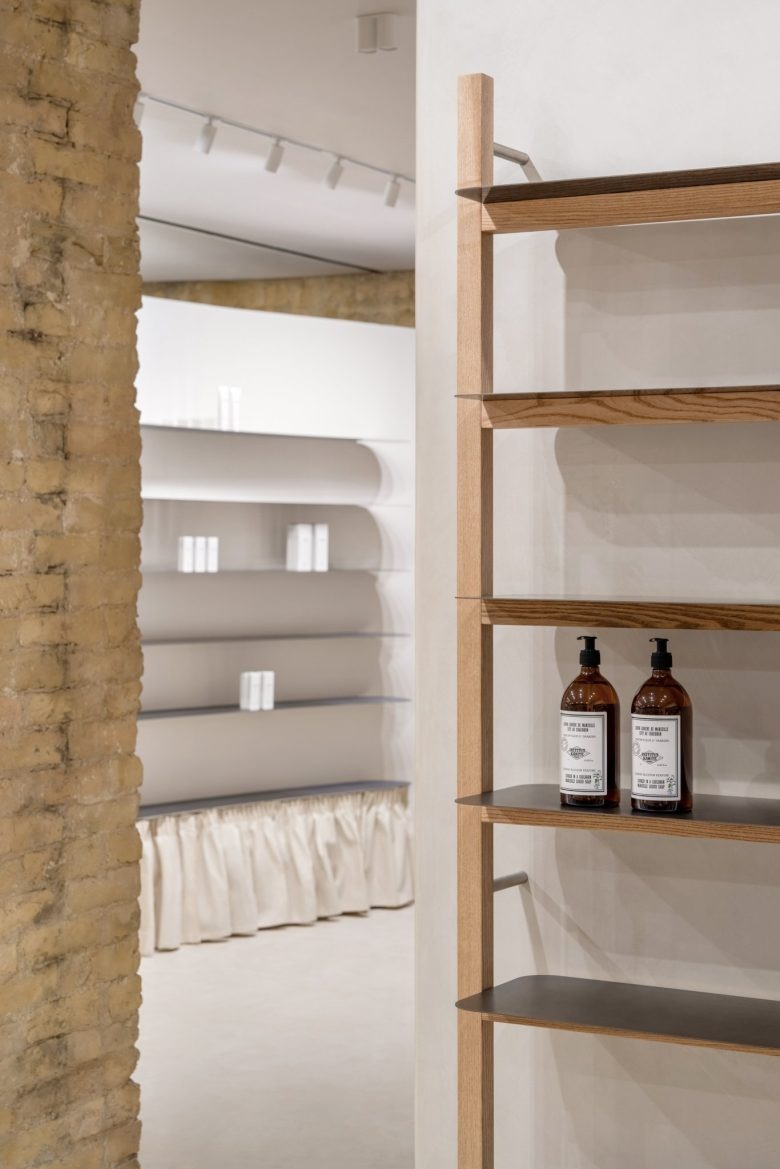 Стеллаж с флаконами в шоуруме PLEKA Professional Cosmetics Showroom