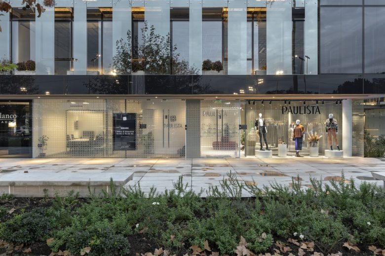 Торговый зал с одеждой и центральным диваном вид изнутри Paulista Store