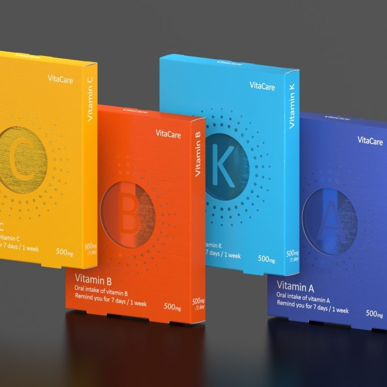 Упаковки витаминов A B C K на сером фоне Vita-Care vitamin tablets