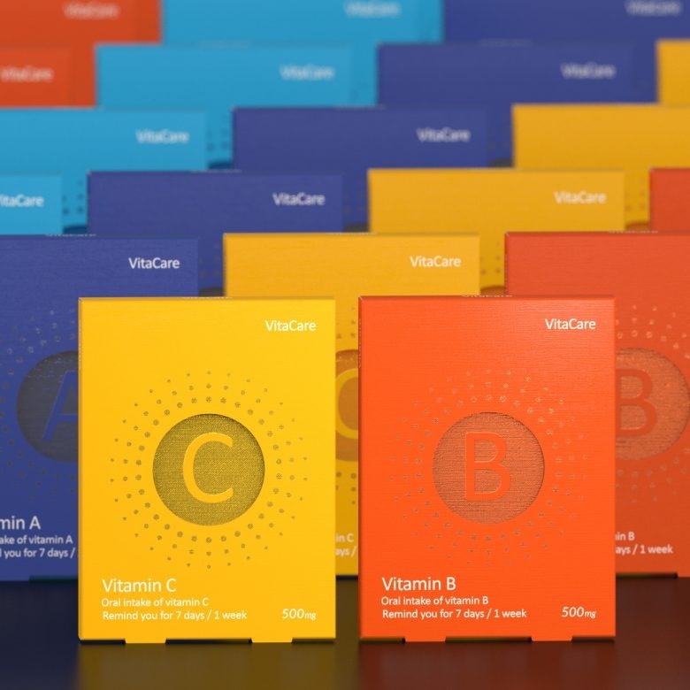 Упаковки витаминов разных цветов в ряд Vita-Care vitamin tablets