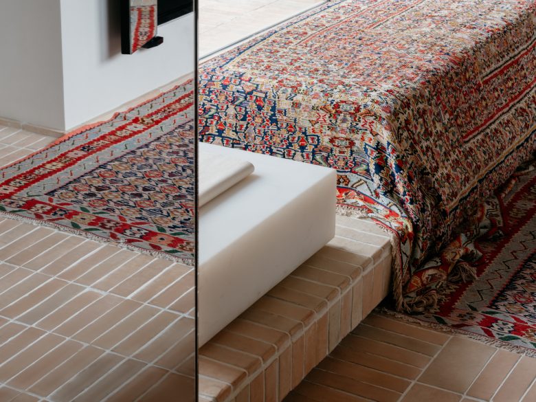 лавочки покрытые коврами Lemaire boutique у окна